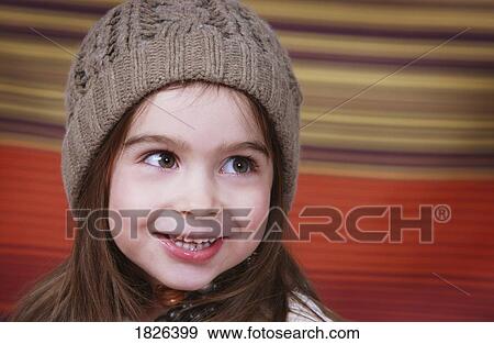 Stock Photo - Girl wearing a wool cap. Fotosearch