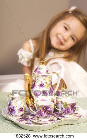 Girl with tea set View Large Photo Image Stock Photo - Girl with tea set. Fotosearch