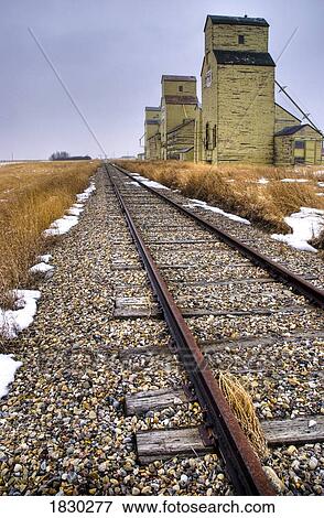 Stock Photo - Grain silos along train tacks, Alberta, Canada. Fotosearch