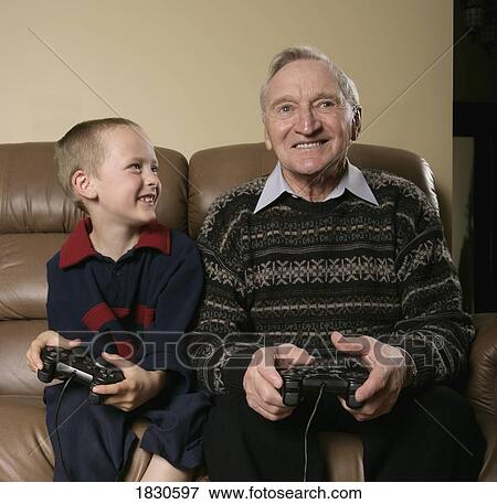 Grandfather and Grandson playing a game View Large Photo Image Stock Photo - Grandfather and Grandson playing a game. Fotosearch