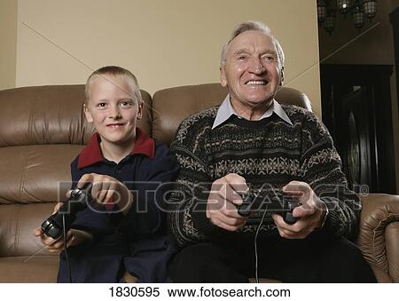 Stock Photography - Grandfather and Grandson playing a game. Fotosearch