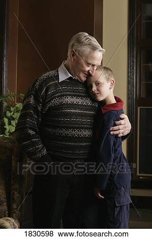 Stock Photo - Grandfather hugging grandson. Fotosearch