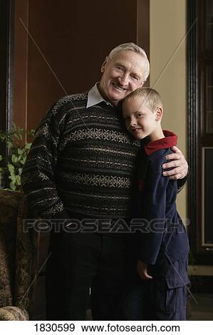 Grandfather hugging grandson View Large Photo Image Stock Photo - Grandfather hugging grandson. Fotosearch