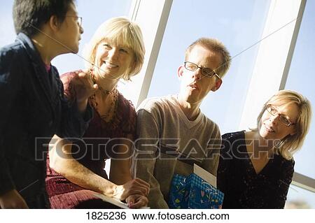 Group of four people visiting View Large Photo Image Stock Photograph - Group of four people visiting. Fotosearch