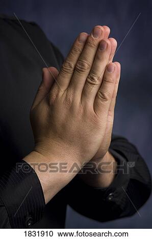 Stock Image - Hands folded in prayer. Fotosearch