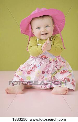 Stock Image - Happy baby girl in summer dress. Fotosearch