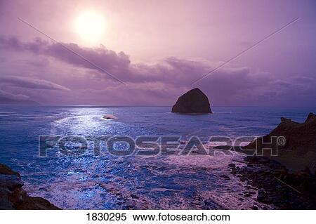 Stock Photography - Haystack Rock at sunset at Cape Kiwanda, Oregon, USA. Fotosearch