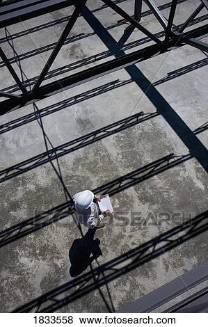 Stock Photo - High angle view of engineer on building site. Fotosearch