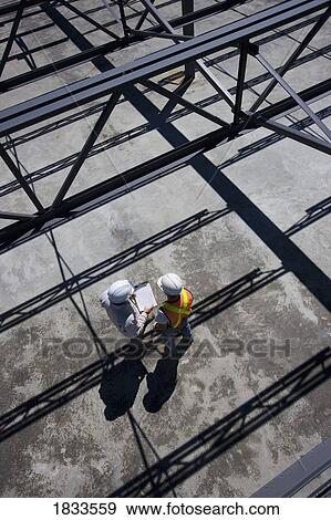 High angle view of engineers on building site View Large Photo Image Stock Photo - High angle view of engineers on building site. Fotosearch