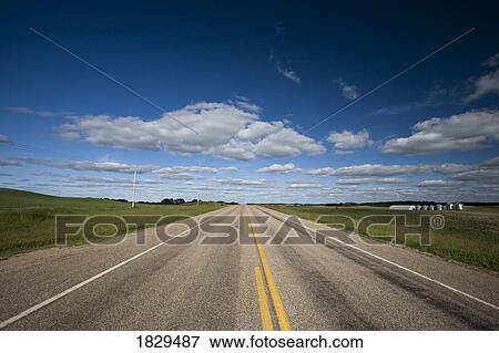 Stock Photo - Highway running through the prairies. Fotosearch