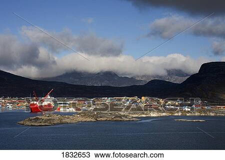 Stock Image - Island Of Qoornoq, Province Of Kitaa, Southern Greenland, Greenland Kingdom Of Denmark, Container Ship Unloading At Nanortalik Port. Fotosearch