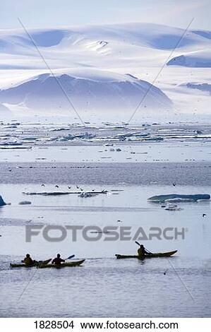 Kayaking ice berg off coast of Nunavut, Canada View Large Photo Image Picture - Kayaking ice berg off coast of Nunavut, Canada. Fotosearch