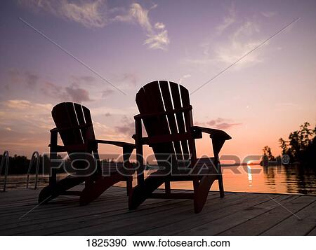 Lake of the Woods, Ontario, Canada, Adirondack chairs on a dock facing the sunset View Large Photo Image Stock Image - Lake of the Woods, Ontario, Canada, Adirondack chairs on a dock facing the sunset. Fotosearch