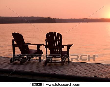 Lake of the Woods, Ontario, Canada, Adirondack chairs on a dock facing the sunset View Large Photo Image Stock Image - Lake of the Woods, Ontario, Canada, Adirondack chairs on a dock facing the sunset. Fotosearch