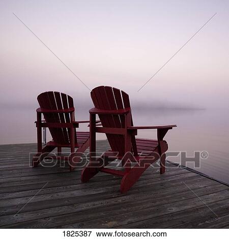 Lake of the Woods, Ontario, Canada, Two red Adirondack chairs on a dock View Large Photo Image Stock Photo - Lake of the Woods, Ontario, Canada, Two red Adirondack chairs on a dock. Fotosearch