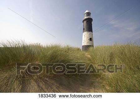 Lighthouse in the dunes View Large Photo Image Stock Photograph - Lighthouse in the dunes. Fotosearch