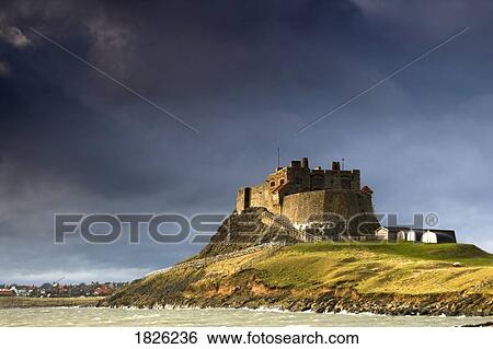 Stock Photograph - Lindisfarne Castle on a volcanic mound called Beblowe Craig, Holy Island, Bewick, England. Fotosearch