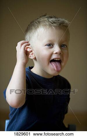 Little boy with his tongue sticking out View Large Photo Image Stock Image - Little boy with his tongue sticking out. Fotosearch