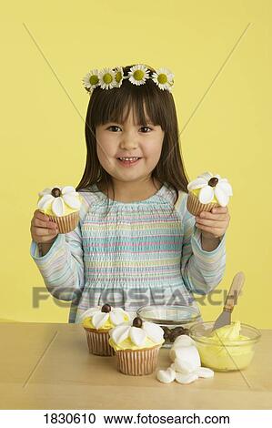 Little girl decorating cupcakes View Large Photo Image Stock Image - Little girl decorating cupcakes. Fotosearch