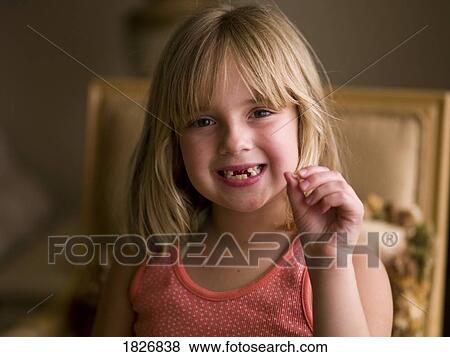Little girl holding a tooth View Large Photo Image Stock Photo - Little girl holding a tooth. Fotosearch