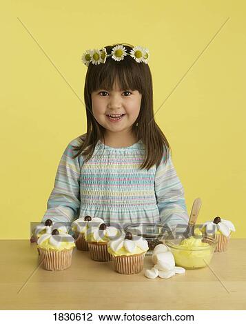 Little girl with decorated cupcakes View Large Photo Image Stock Image - Little girl with decorated cupcakes. Fotosearch