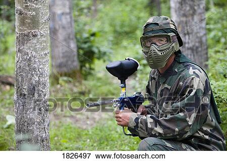 Man aiming paintball gun View Large Photo Image Stock Photo - Man aiming paintball gun. Fotosearch