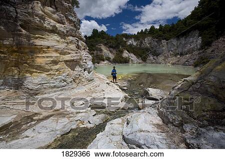 Man at geothermal site, Wai-O-Tapu Thermal Wonderland on North Island of New Zealand View Large Photo Image Stock Photograph - Man at geothermal site, Wai-O-Tapu Thermal Wonderland on North Island of New Zealand. Fotosearch