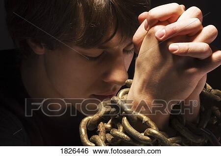 Man in chains praying View Large Photo Image Stock Photograph - Man in chains praying. Fotosearch