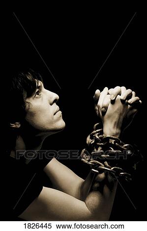 Man in chains with hands clasped View Large Photo Image Stock Photography - Man in chains with hands clasped. Fotosearch