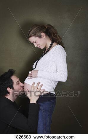 Man kissing woman's pregnant belly View Large Photo Image Stock Photo - Man kissing woman's pregnant belly. Fotosearch