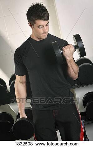 Man Lifting Weights In Gym View Large Photo Image Stock Photo - Man Lifting Weights In Gym. Fotosearch