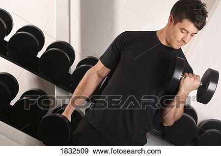 Man Lifting Weights In Gym View Large Photo Image Stock Photo - Man Lifting Weights In Gym. Fotosearch