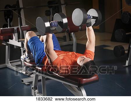 Man lifting weights View Large Photo Image Stock Image - Man lifting weights. Fotosearch