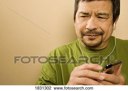 Man listening to music player View Large Photo Image Stock Image - Man listening to music player. Fotosearch