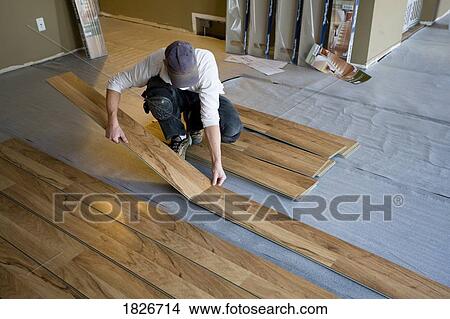 Picture - Man renovating the floor. Fotosearch
