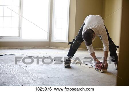 Man sanding a floor View Large Photo Image Stock Photograph - Man sanding a floor. Fotosearch