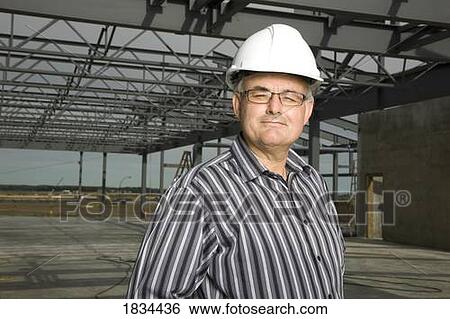 Man wearing a hard hat View Large Photo Image Stock Photograph - Man wearing a hard hat. Fotosearch