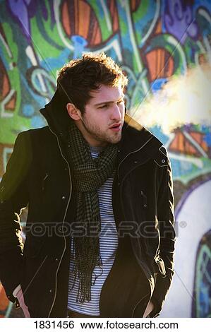 Stock Photograph - Man wearing coat and scarf. Fotosearch