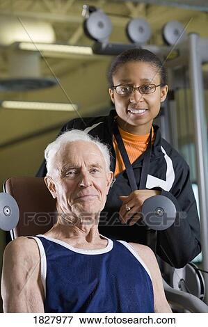 Stock Photo - Man with a personal trainer. Fotosearch