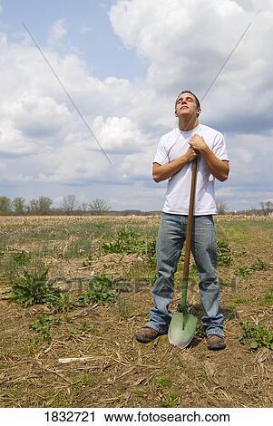 Stock Image - Man with a shovel. Fotosearch