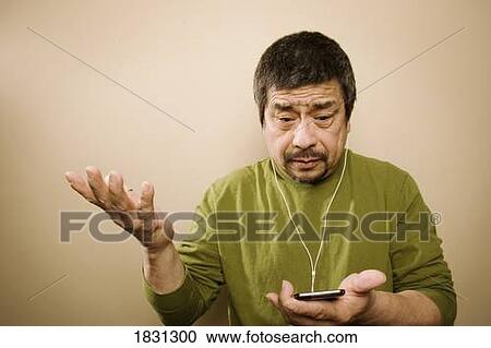 Stock Image - Man with MP3 player. Fotosearch