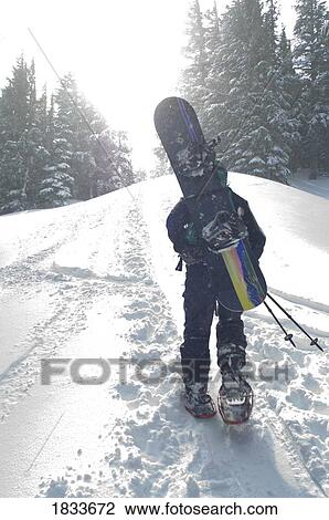 Man with snowboard hiking up mountain View Large Photo Image Stock Image - Man with snowboard hiking up mountain. Fotosearch