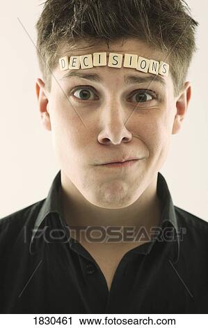 Man with the word "decisions" spelled with letter tiles on his head View Large Photo Image Stock Image - Man with the word "decisions" spelled with letter tiles on his head. Fotosearch