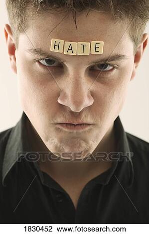 Man with the word 'hate' spelled with letter tiles on his head View Large Photo Image Stock Image - Man with the word 'hate' spelled with letter tiles on his head. Fotosearch