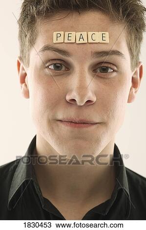 Man with the word 'peace' spelled with letter tiles on his head View Large Photo Image Stock Image - Man with the word 'peace' spelled with letter tiles on his head. Fotosearch