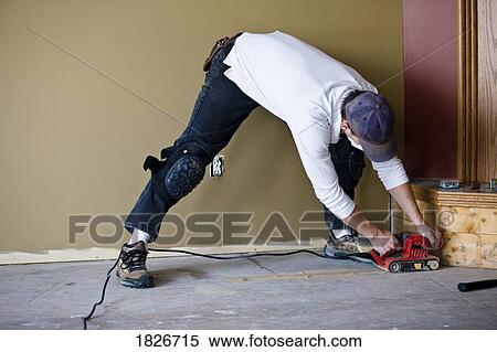 Stock Photography - Man working on a floor. Fotosearch