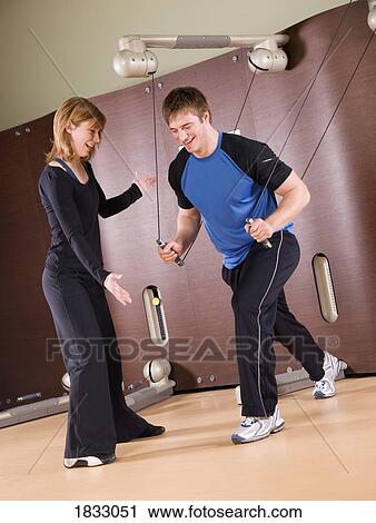 Man working out with woman View Large Photo Image Stock Image - Man working out with woman. Fotosearch
