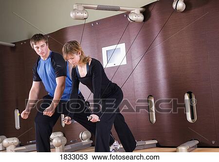 Stock Image - Man working out with woman. Fotosearch