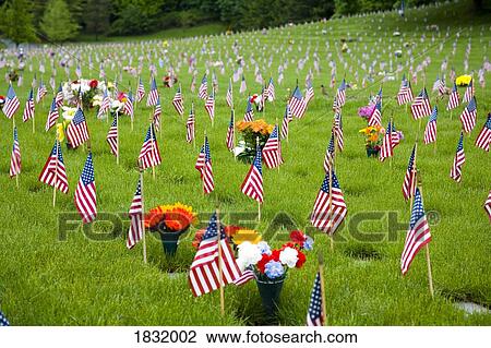 Stock Image - Memorial Flowers And Flags In A Graveyard In Oregon, USA. Fotosearch