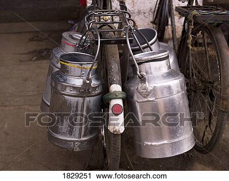 Milk jugs on bicycle View Large Photo Image Stock Image - Milk jugs on bicycle. Fotosearch